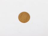 a close up of a gold coin on a white surface