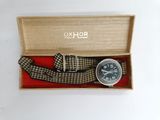 a watch that is in a box with a tie around it