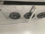 two fans that are attached to the ceiling in the bathroom