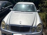 two cars parked next to each other in a parking lot