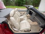 the interior of a red car with the door open