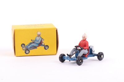 toy figurine of an old man driving a toy car in front of a box