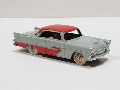 a toy car that is sitting on a white surface