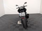 a motorcycle that is parked in a room with a checkered floor