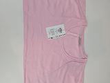 a pink t shirt with a tag on the back of it