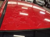 a red car that has been painted red in a garage