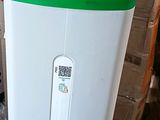 a green and white trash can sitting next to a trash can
