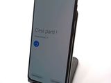 a close up of a cell phone on a stand on a table