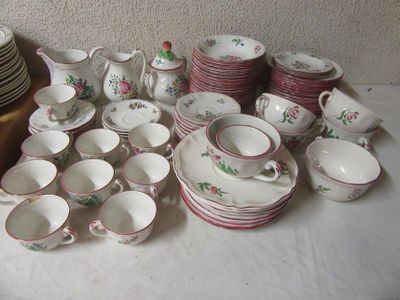 a lot of dishes and cups sitting on a table