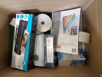 a cardboard box filled with various electronic devices and other items