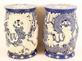 pair of blue and white vases with dragon designs on them