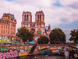 a boat that is going down the river with graffiti all over it