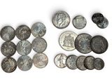some old coins are laying out on a white surface