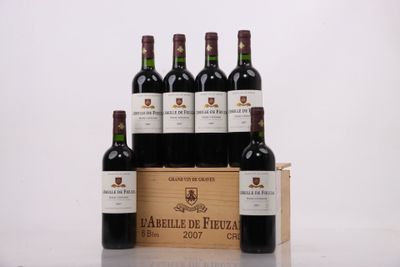 six bottles of red wine in a wooden box on a table