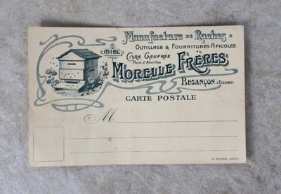 une vieille carte postale sur laquelle figure une ruche