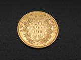 three different types of gold coins on a black surface