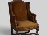 an old fashioned chair with a brown upholstered seat
