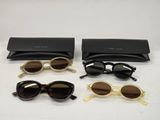 three pairs of sunglasses and a case on a table