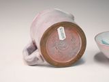a white bowl and a brown cup on a table