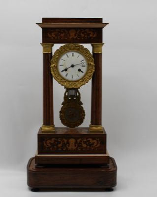 a clock that is sitting on top of a wooden stand