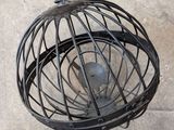 a metal cage with a metal ball inside of it