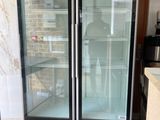 two refrigerators that are sitting in a kitchen