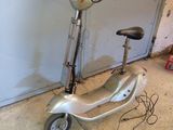 a scooter that is parked in front of a garage door