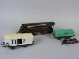deux petits trains et un wagon posés sur une surface blanche