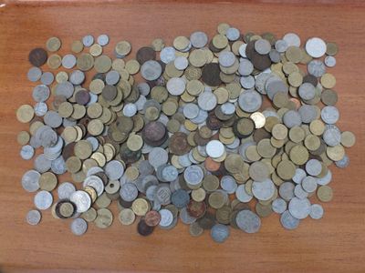 a pile of coins sitting on a wooden table