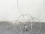 a metal object that is sitting on the ground next to a wall