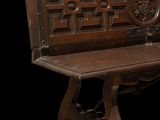 a wooden bench that has a carved design on it