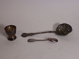 two spoons and a spoon rest on a table