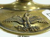 a brass plate with a bird on it