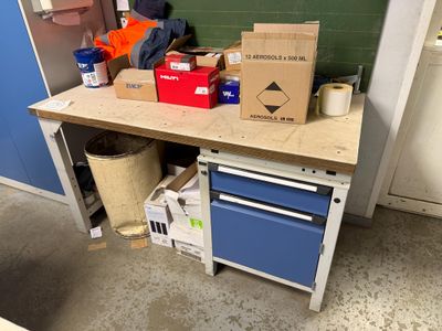 a workbench with a lot of boxes on top of it