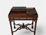 a small wooden table with a tray on top of it