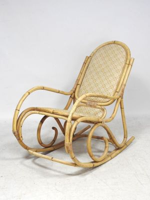 a wicker rocking chair with a wicker seat