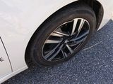 a close up of a white car with black rims