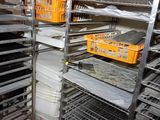 many racks with trays of food on them in the kitchen