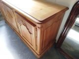 a wooden cabinet with a mirror on top of it