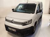La camionnette blanche est garée dans la pièce blanche de l'immeuble.