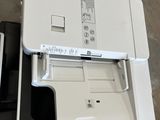 a white printer sitting on top of a black and white box