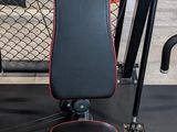 a close up of a gym machine with a red and black seat