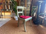 a chair that has a red cushion on it in a room