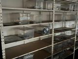 a room with a lot of shelves and bins on it