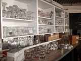 many glasses on the shelves in the room