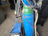 une borne d'incendie bleue à laquelle est raccordé un tuyau