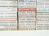 many books stacked on top of each other on a table