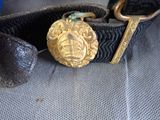 a black belt with a gold buckle and a black belt with a gold buckle on it