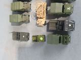 a lot of toy army vehicles that are on the table