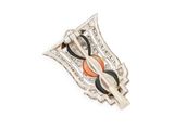 a close up of a brooch with a red stone in it